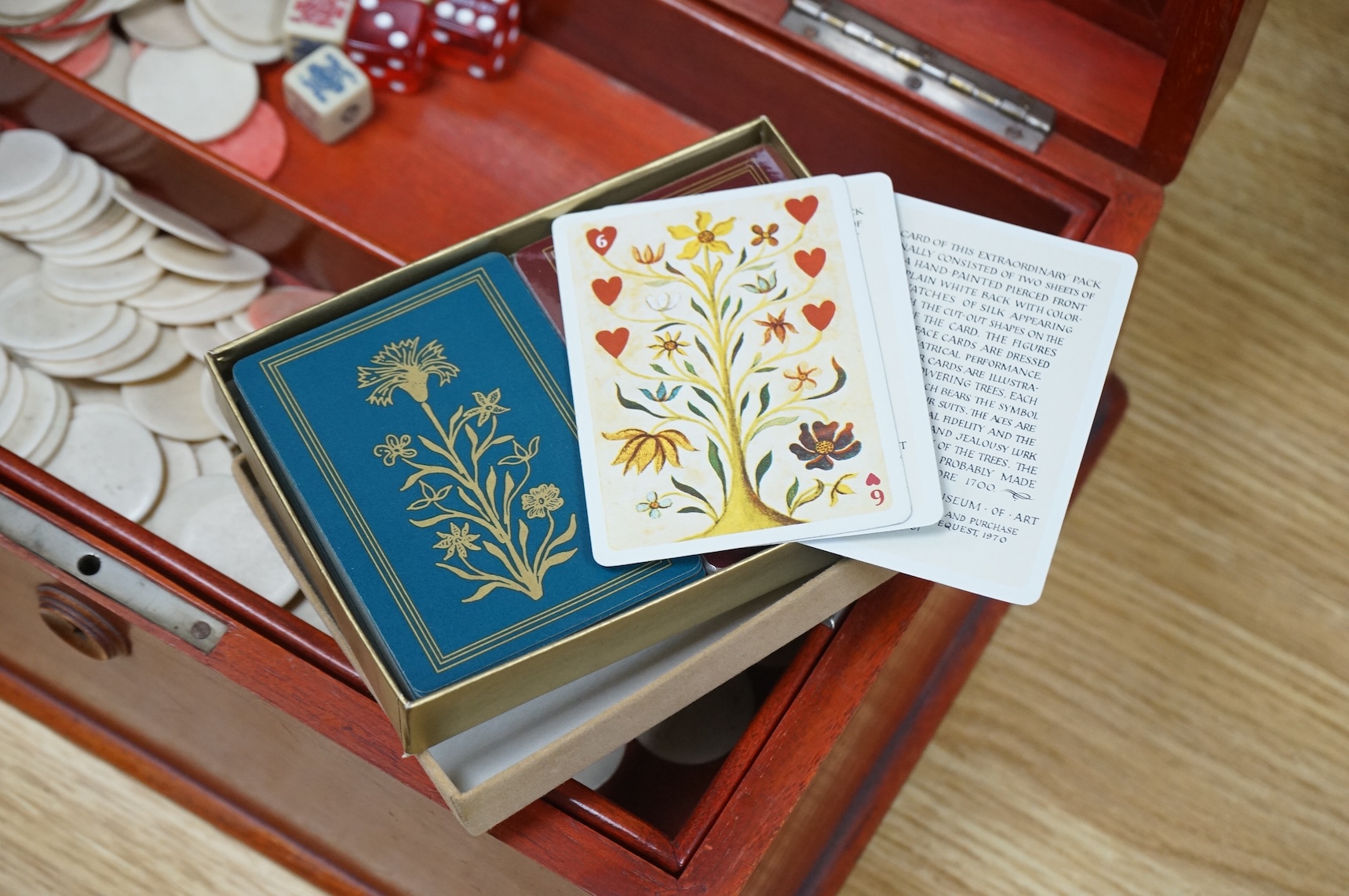 A French stained teak games box with bone counters, various playing cards, etc, 30cm wide